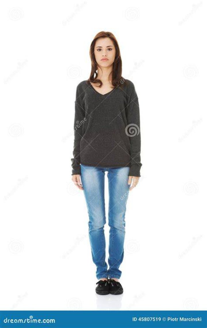a woman standing in front of a brick fireplace holding two paddles and